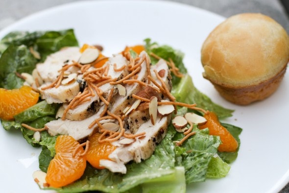 A mandarin chicken salad on a white plate.