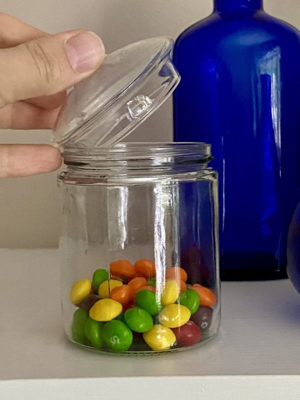 glass jar filled with Skittles.
