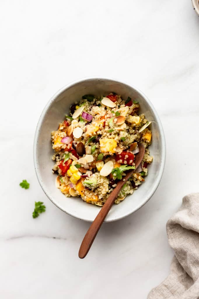 A bowl of southwest quinoa salad with a linen napkin on the side